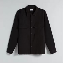 Relaxed fit shirt in black pleated oversized shirt with two flap pockets plastic button placket